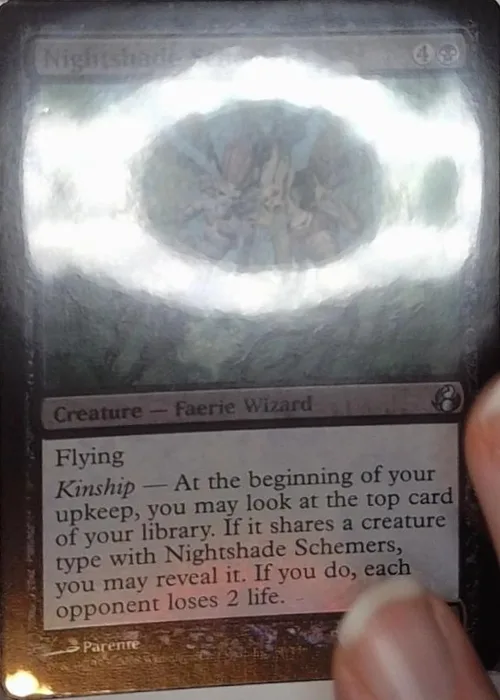 Card with a bright lamp reflection across it