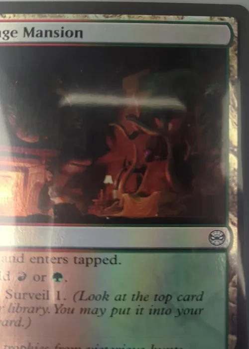 Finger covering the card's collector number